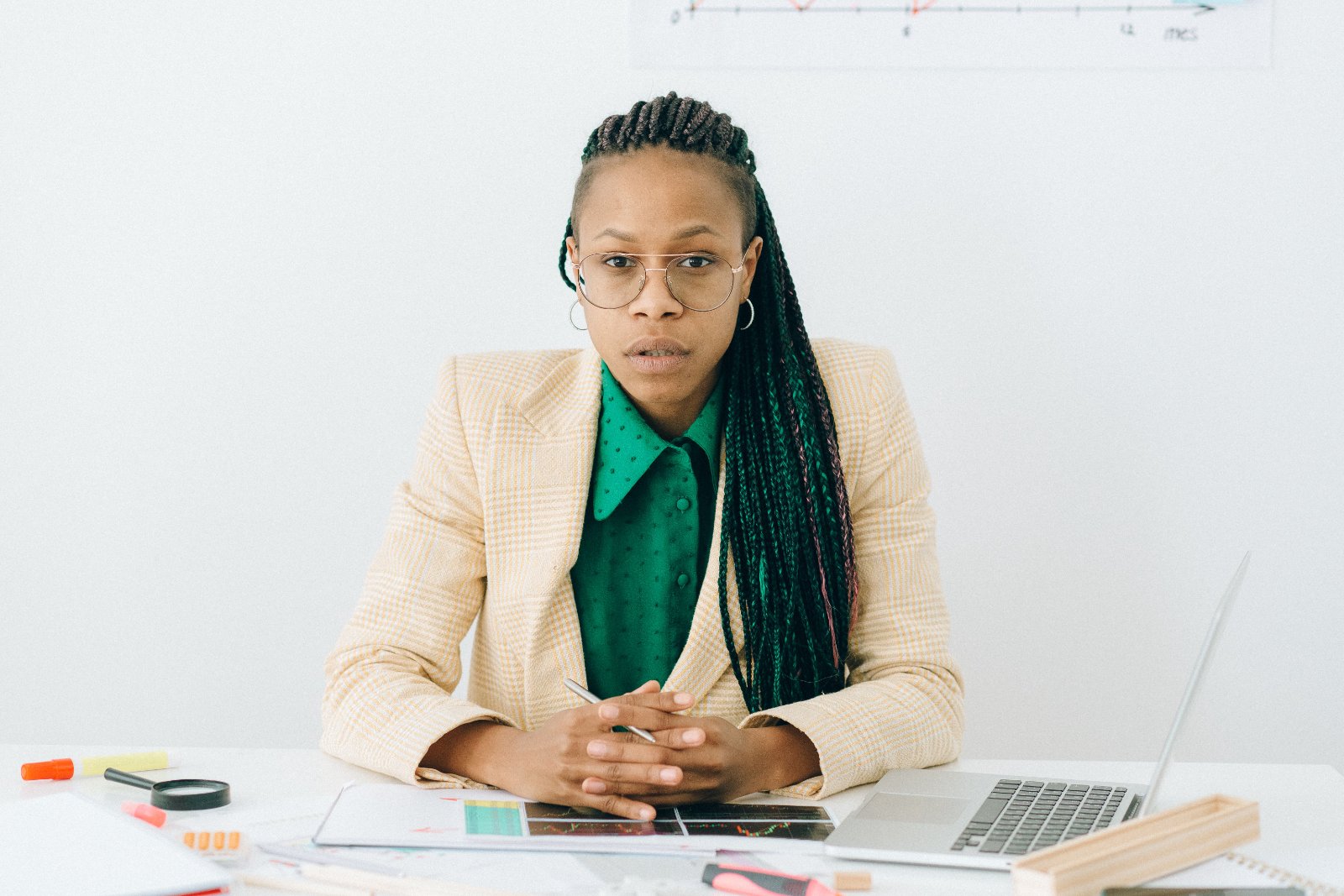 Black professional having a calm, direct conversation with a supervisor in an office setting.