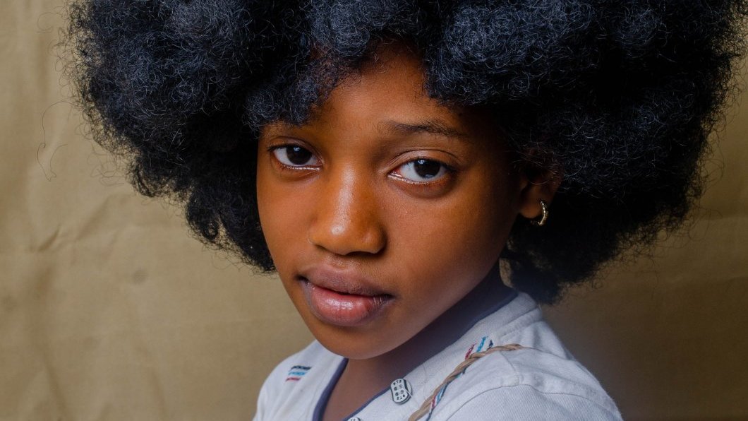 Black mother and daughter having a serious, supportive conversation.
