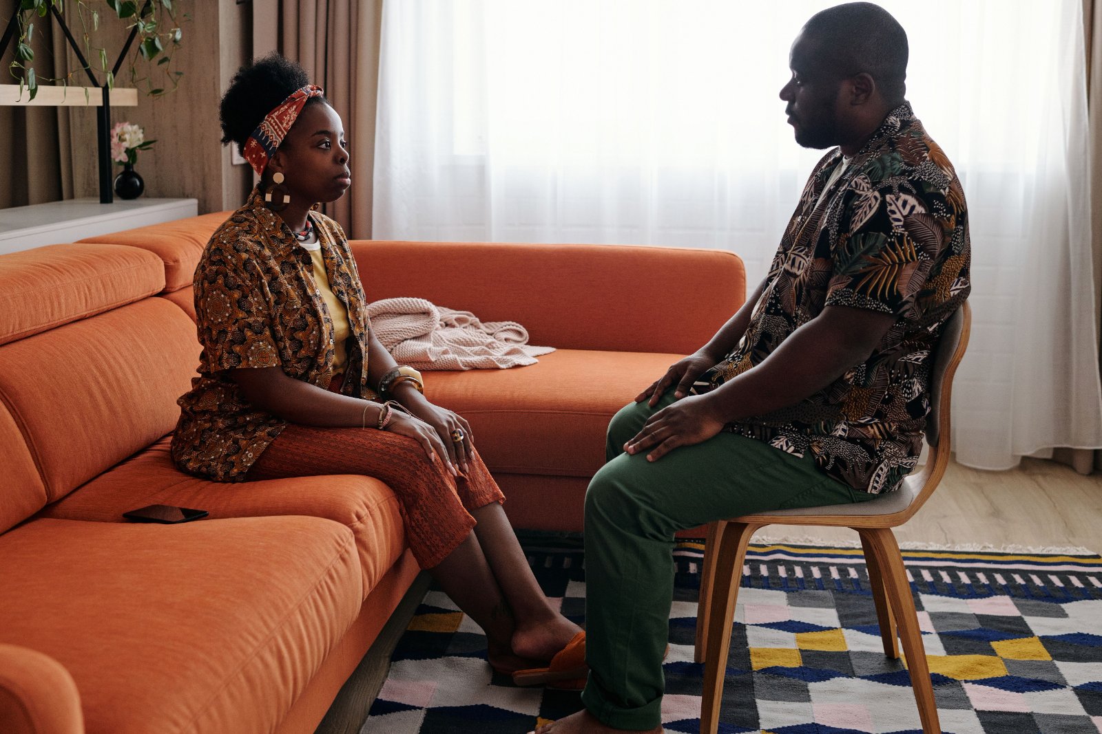 Two Black women having a supportive conversation at home.